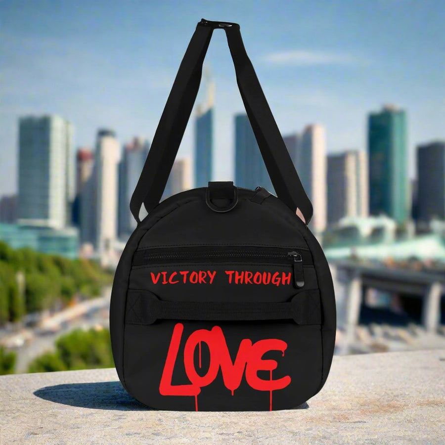 VICTORY THROUGH LOVE - PREMIUM DUFFLE BAG - BLACK UNIVERSE